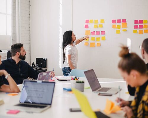 woman-placing-sticky-notes-on-wall