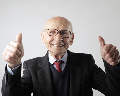 positive-senior-man-in-eyeglasses-showing-thumbs-up-and-3824771