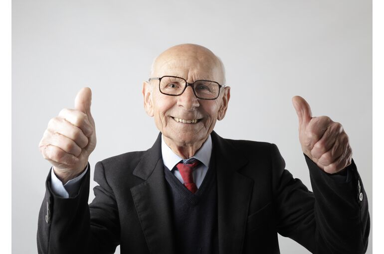 positive-senior-man-in-eyeglasses-showing-thumbs-up-and-3824771